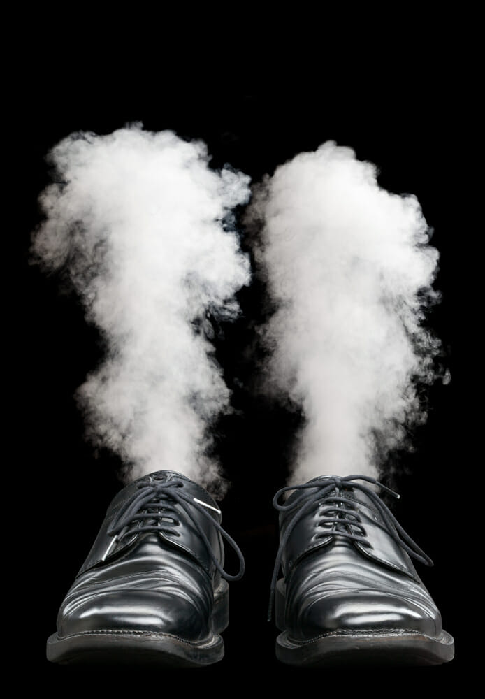 Business man's shoes with magic smoke where the person just has disappeared
