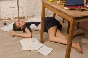 Lifeless college girl on a floor