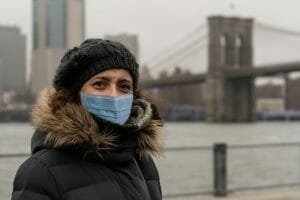 woman wearing surgical mask in new york, in Dumbo neighborhood
