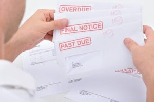 Close-up Of A Man Holding Pending Due Statements