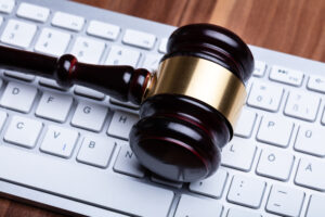 Close-up Photo Of Wooden Gavel On Keyboard